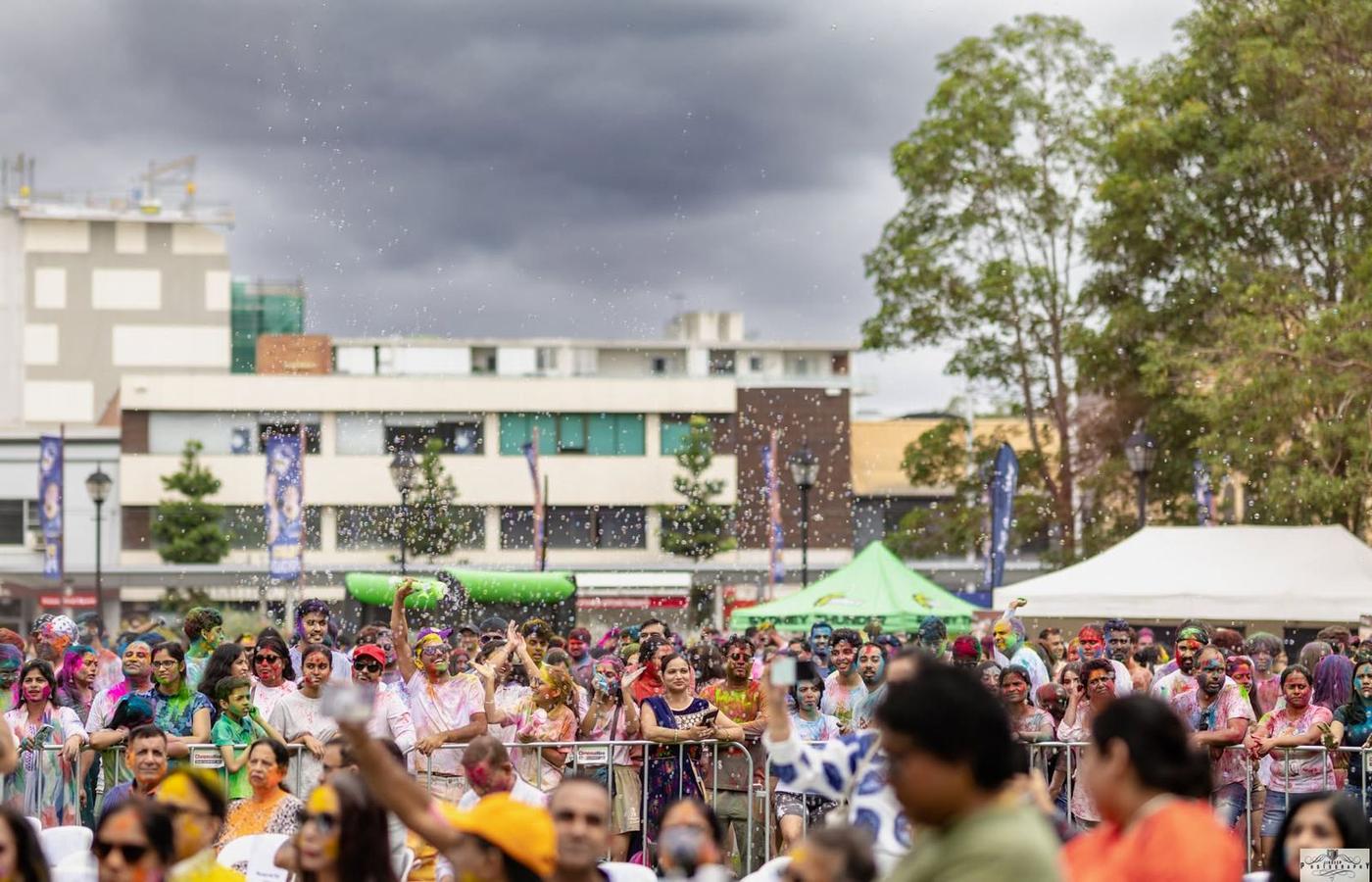 Water and colour over the crowd as the sky darkens